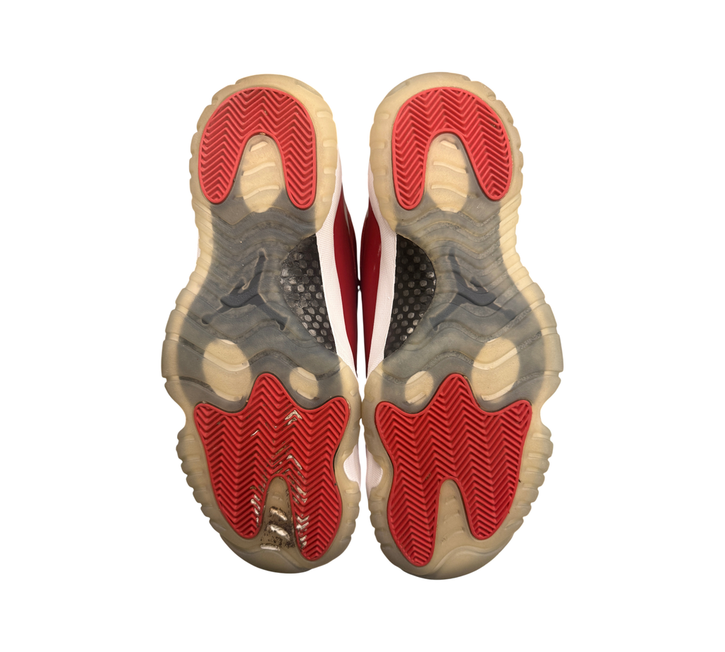 Genesis Boutique used Jordan 11 Win Like 96 sneakers showing red and white outsoles with natural yellowing.