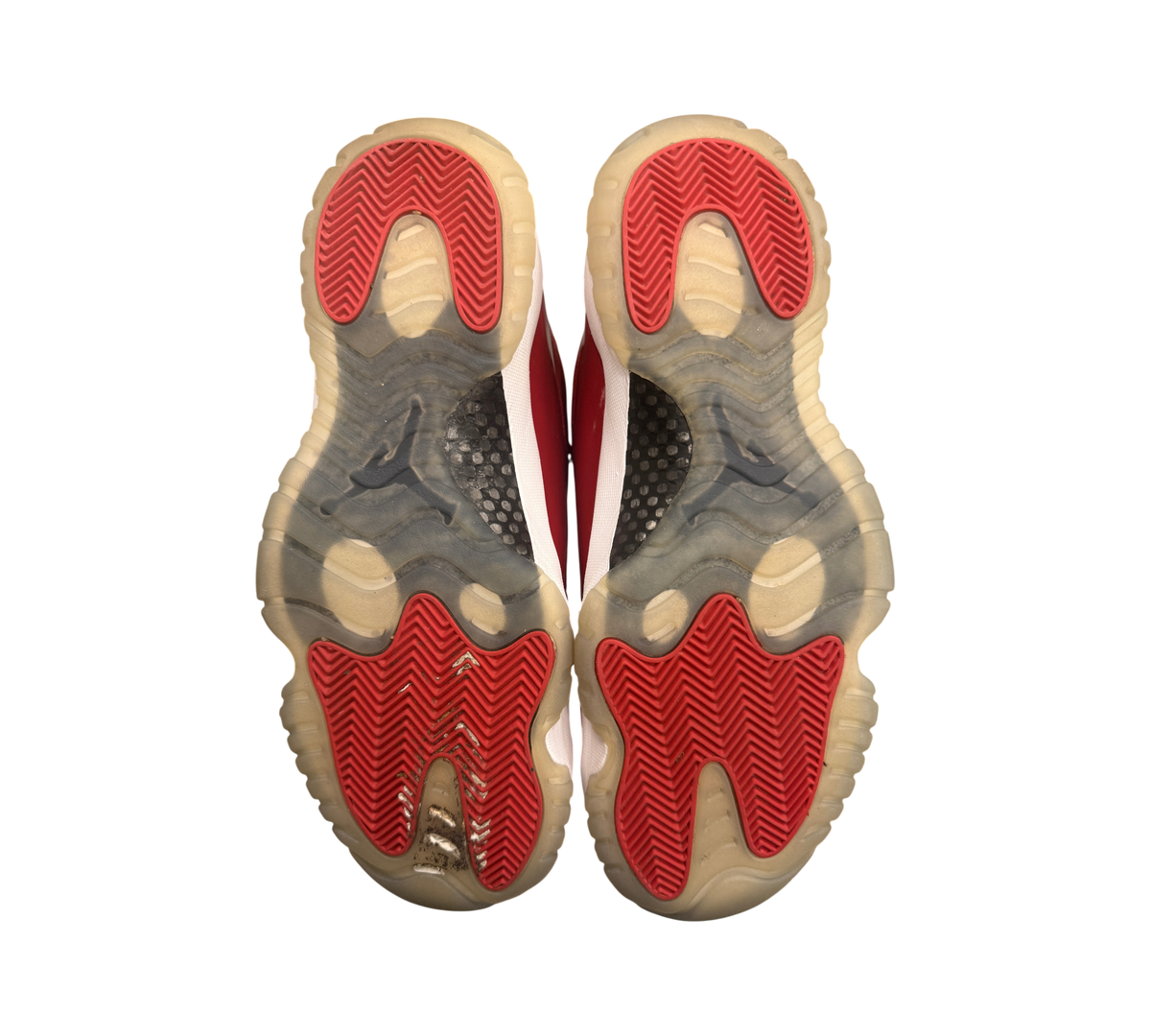 Genesis Boutique used Jordan 11 Win Like 96 sneakers showing red and white outsoles with natural yellowing.