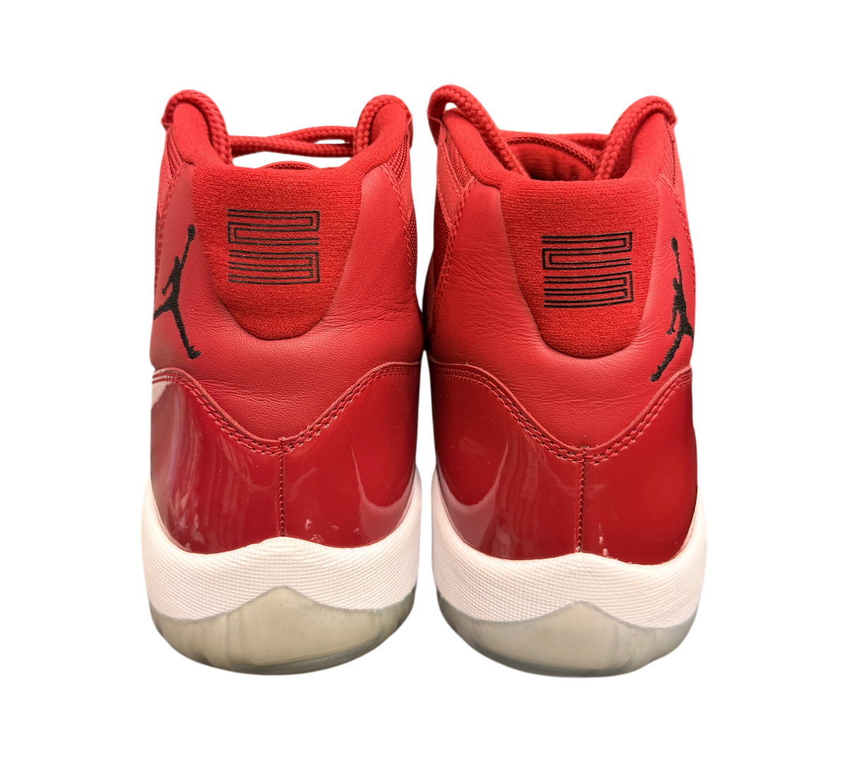 Genesis Boutique pre-owned Jordan 11 Win Like '96 sneakers in red with patent leather and yellowed translucent soles.