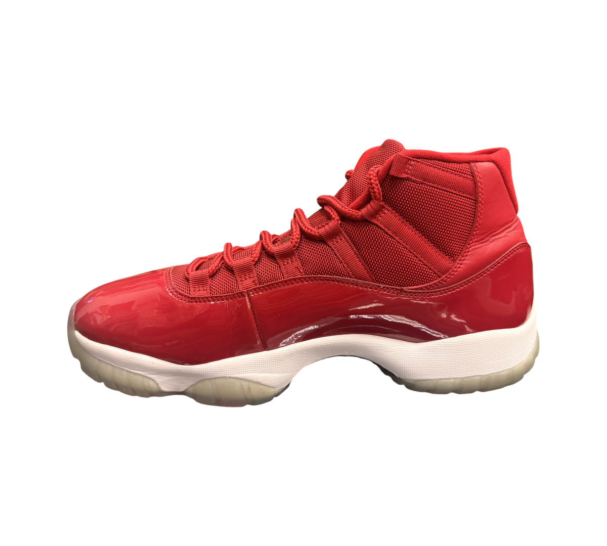 Genesis Boutique Jordan 11 Win Like 96 sneakers in red with patent leather and slightly yellowed soles.