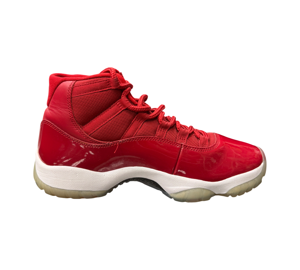 Genesis Boutique Jordan 11 Win Like 96 sneakers in red patent leather and mesh with a white midsole and icy outsole.