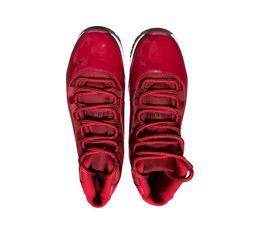 Genesis Boutique Jordan 11 Win Like 96 sneakers in gym red with patent leather and mesh upper, top-down view.