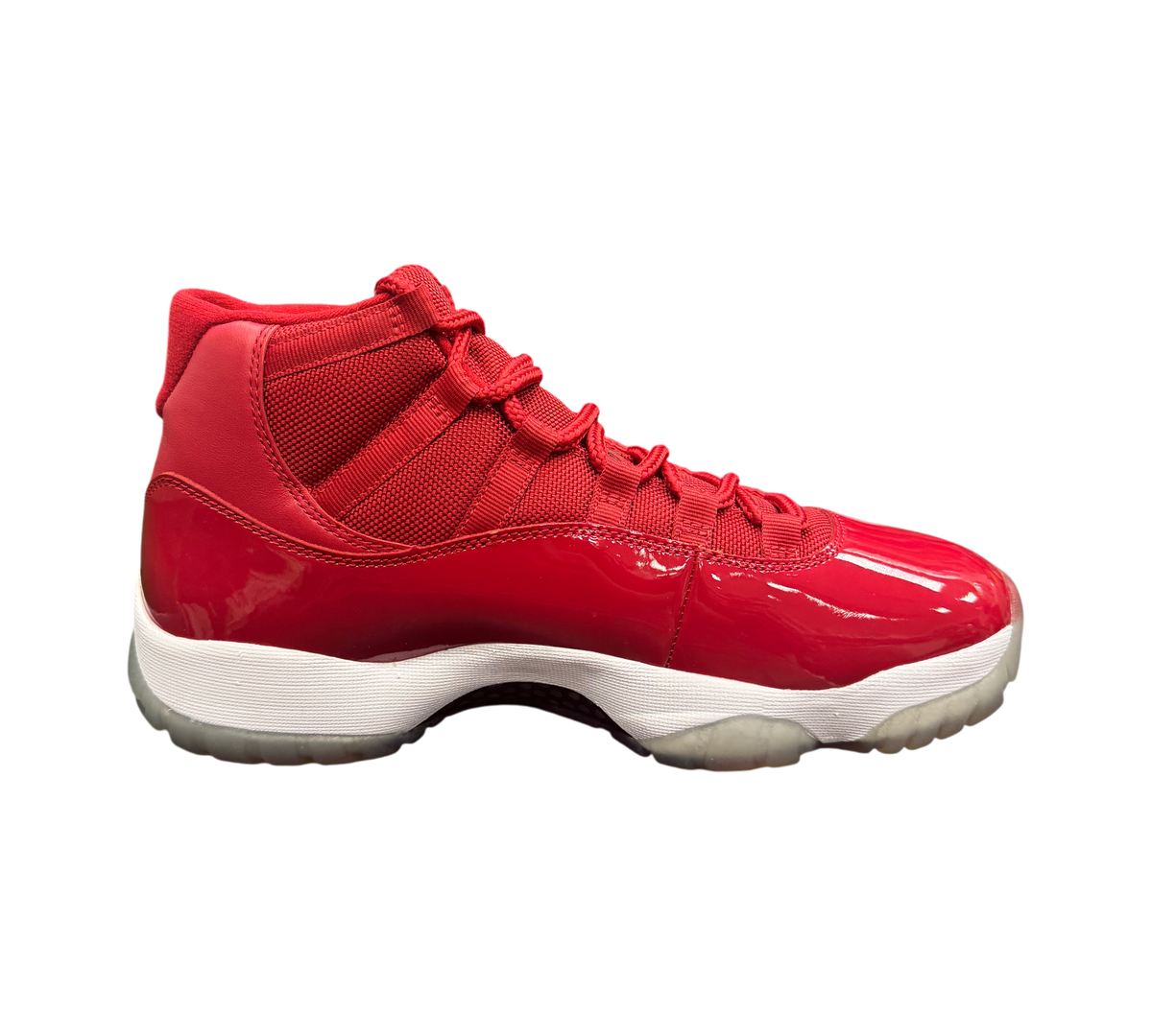 Genesis Boutique Jordan 11 Win Like 96 sneakers in gym red with patent leather and mesh upper on a shoe box