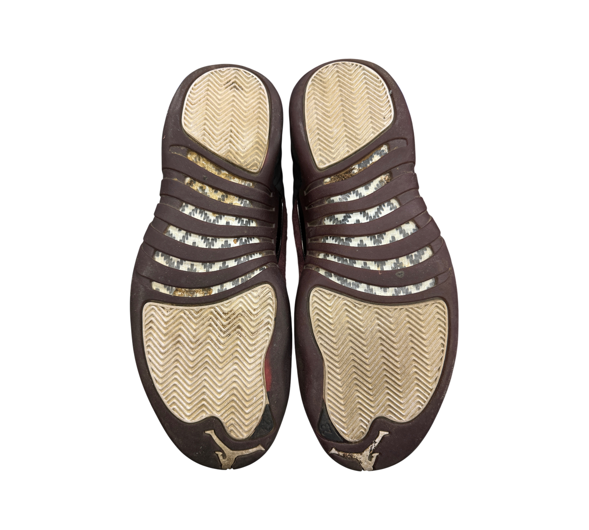 Genesis Boutique used Jordan 12 A Ma Maniere Black sneakers showing worn outsoles with herringbone traction pattern