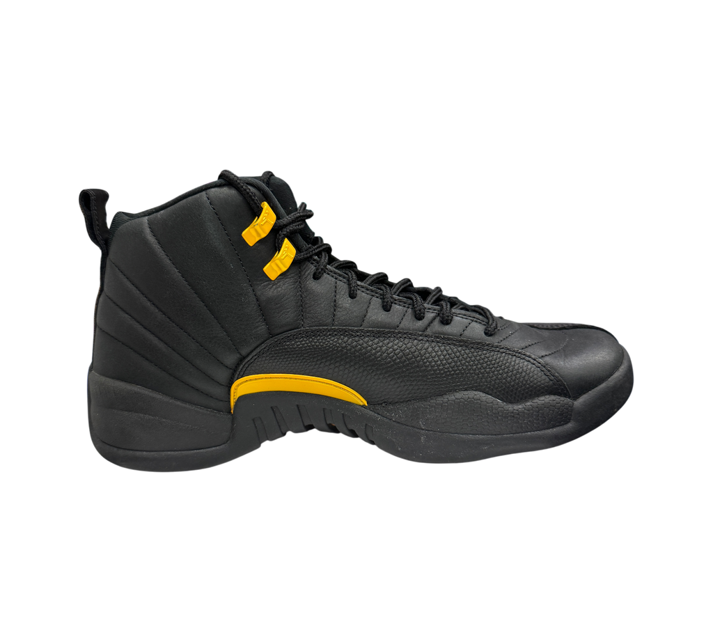Genesis Boutique Jordan 12 Black Taxi sneaker in black leather with yellow accents and textured mudguard side view