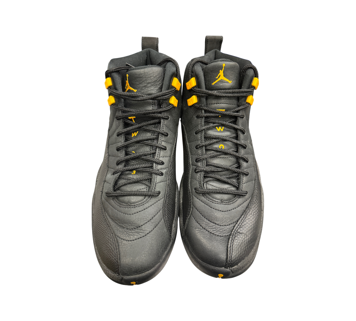Genesis Boutique pre-owned Jordan 12 Black Taxi sneakers in black leather with yellow accents and lace hardware.