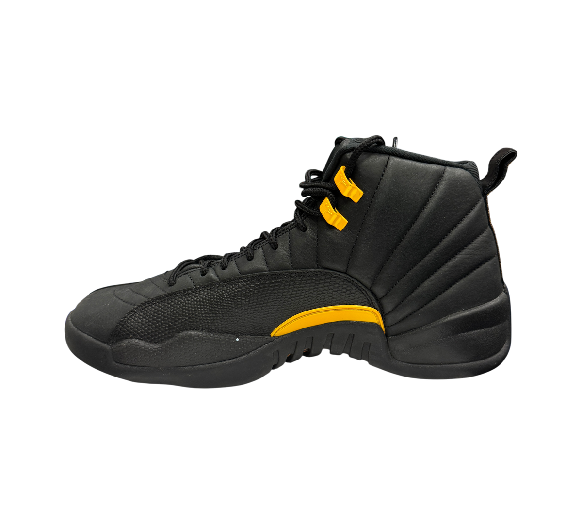 Genesis Boutique Jordan 12 Black Taxi sneakers in black leather with yellow accents, side profile view.