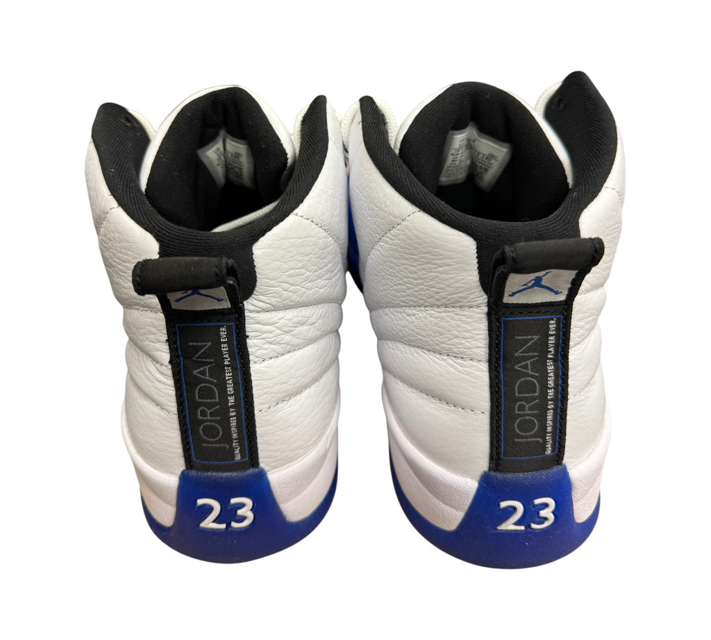 Genesis Boutique used Jordan 12 Blueberry sneakers featuring white leather, blue accents, and number 23 heel detail.