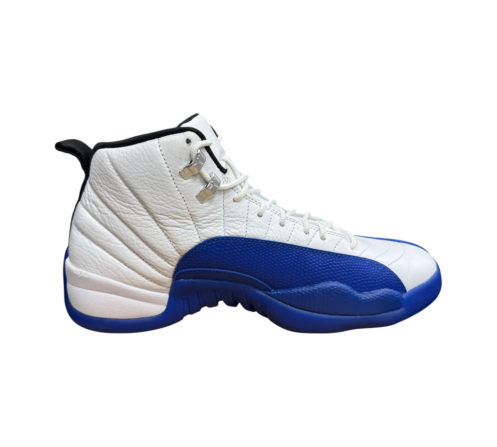 Genesis Boutique Jordan 12 Blueberry sneakers in white and blue leather with silver eyelets on a shoebox.