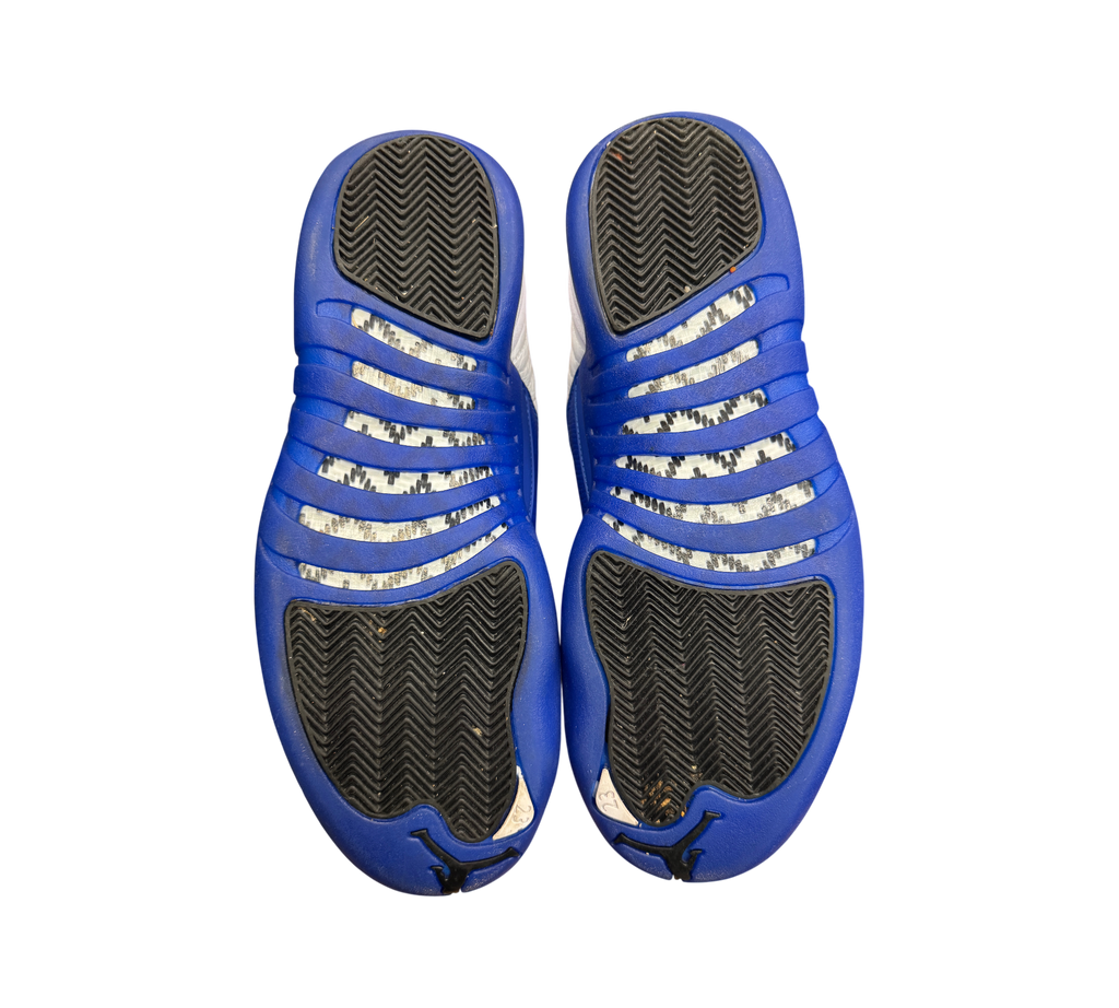 Genesis Boutique used Jordan 12 Blueberry sneakers showing the blue and black herringbone traction outsoles.