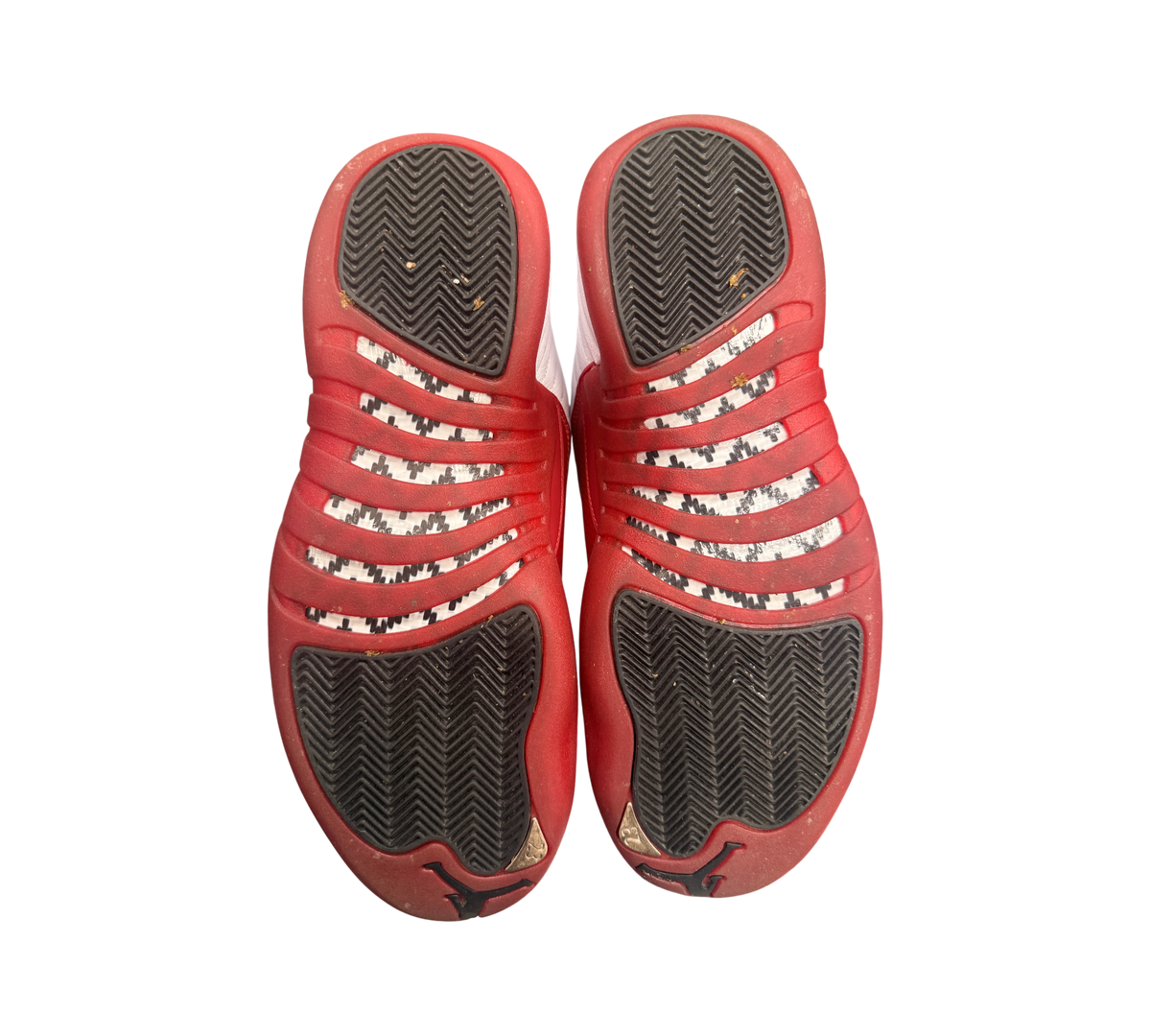 Genesis Boutique Jordan 12 "Cherry 2023" sneakers, red and white with black soles and herringbone pattern.