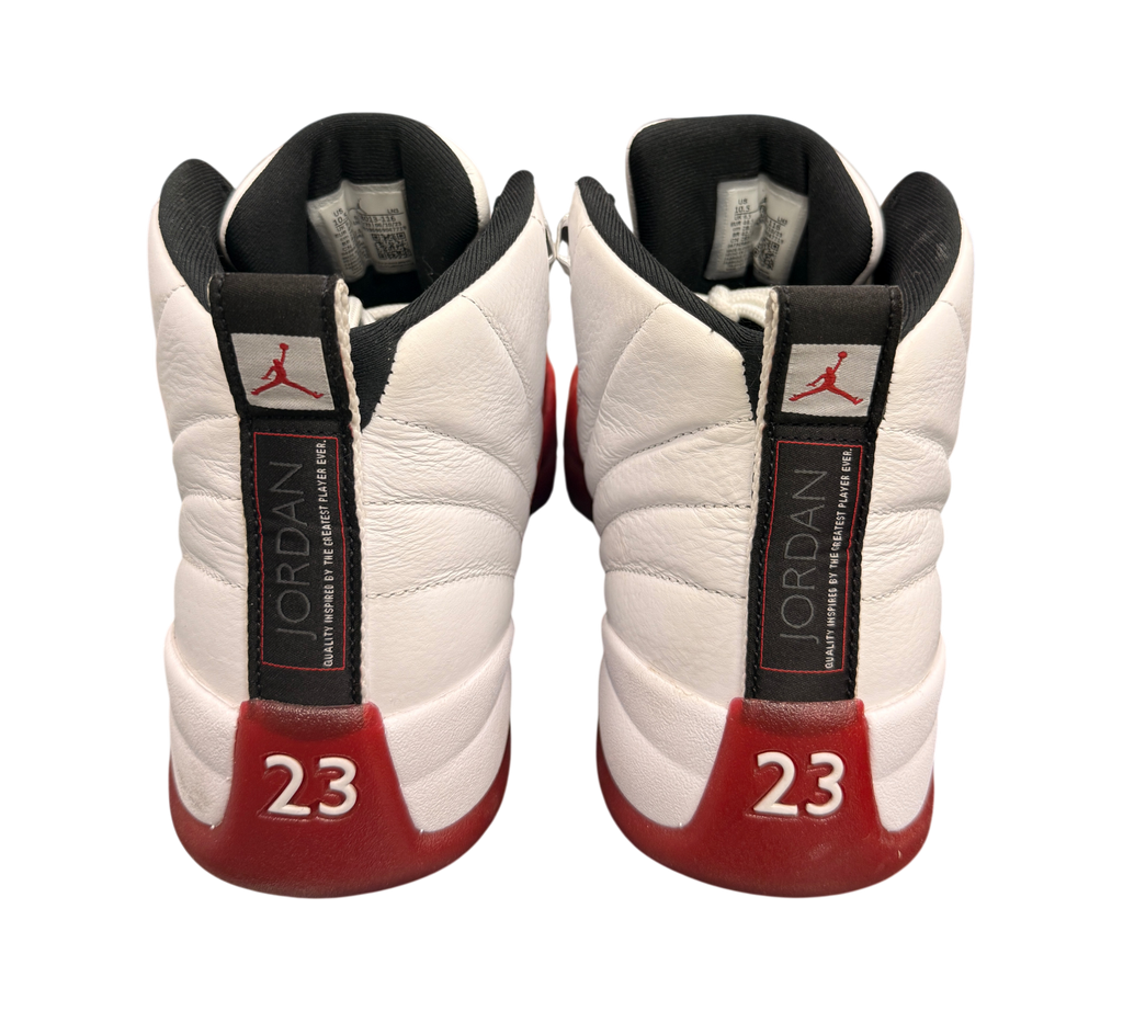 Genesis Boutique used Jordan 12 Cherry sneakers featuring white leather, red accents, and 23 branding on the heel.