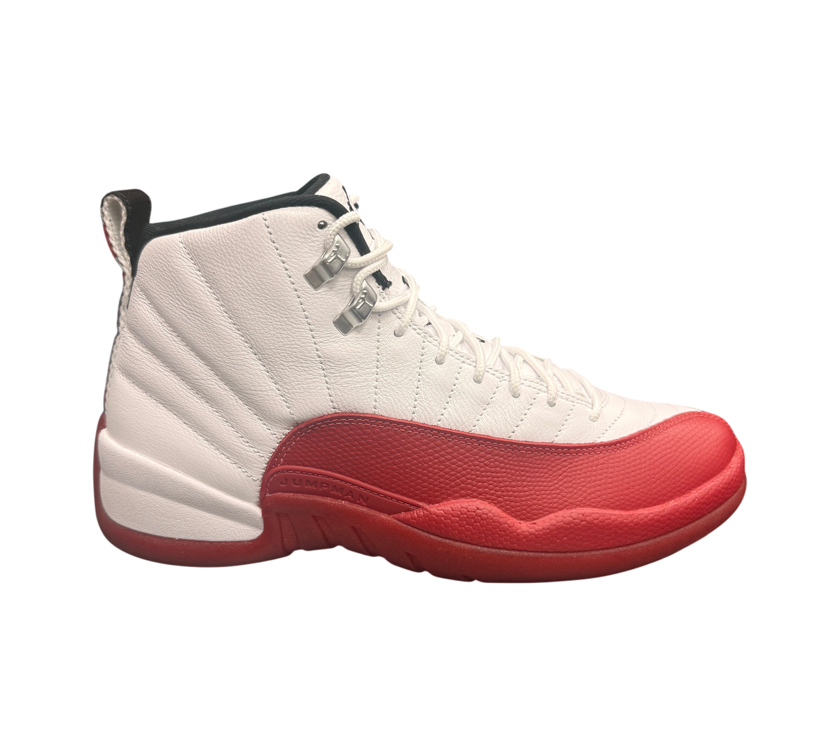 Genesis Boutique white and red leather Jordan 12 "Cherry 2023" sneakers with silver eyelets and Jumpman logo.