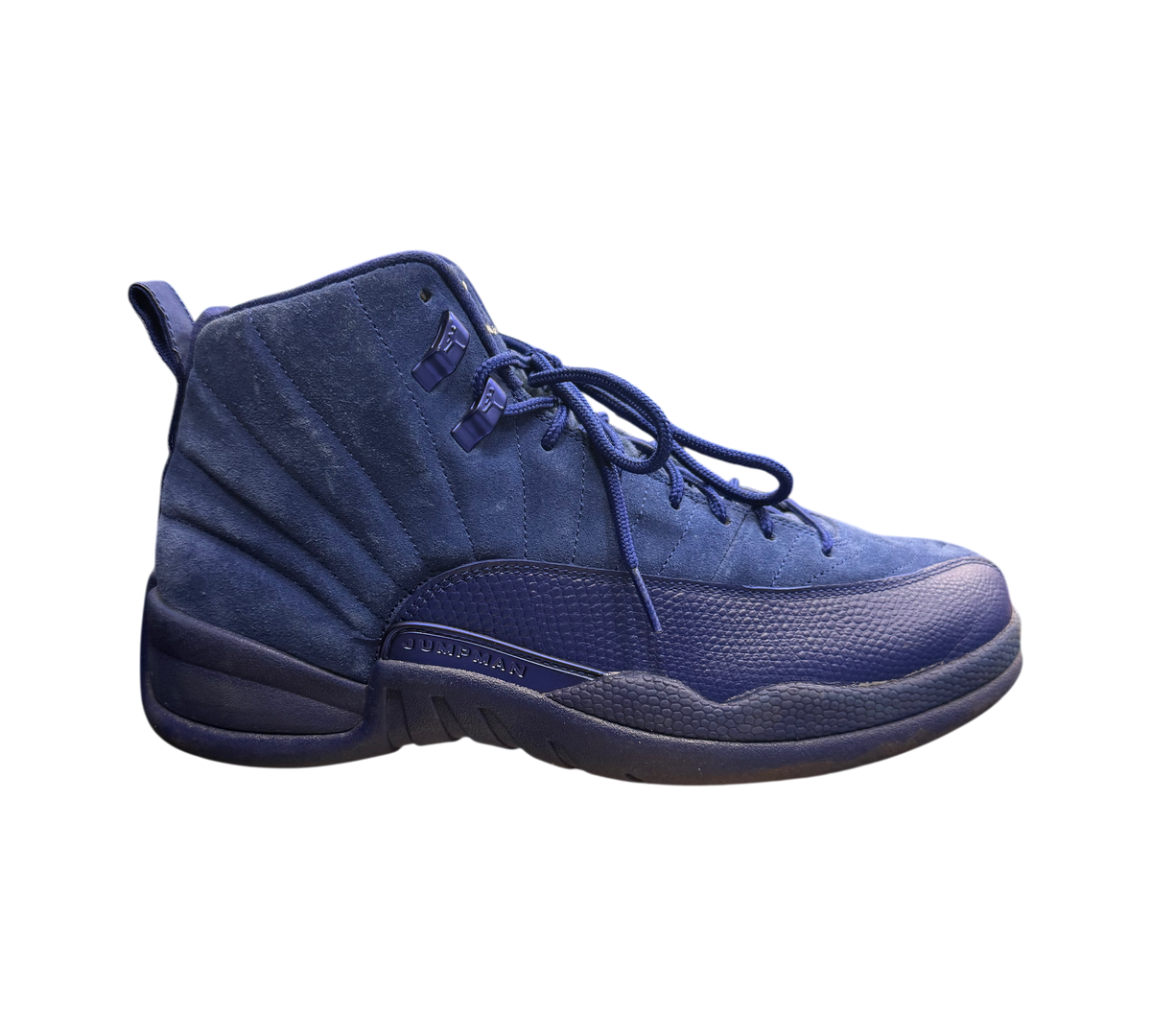 Genesis Boutique Jordan 12 Deep Royal Blue suede sneakers with Jumpman logo detail.