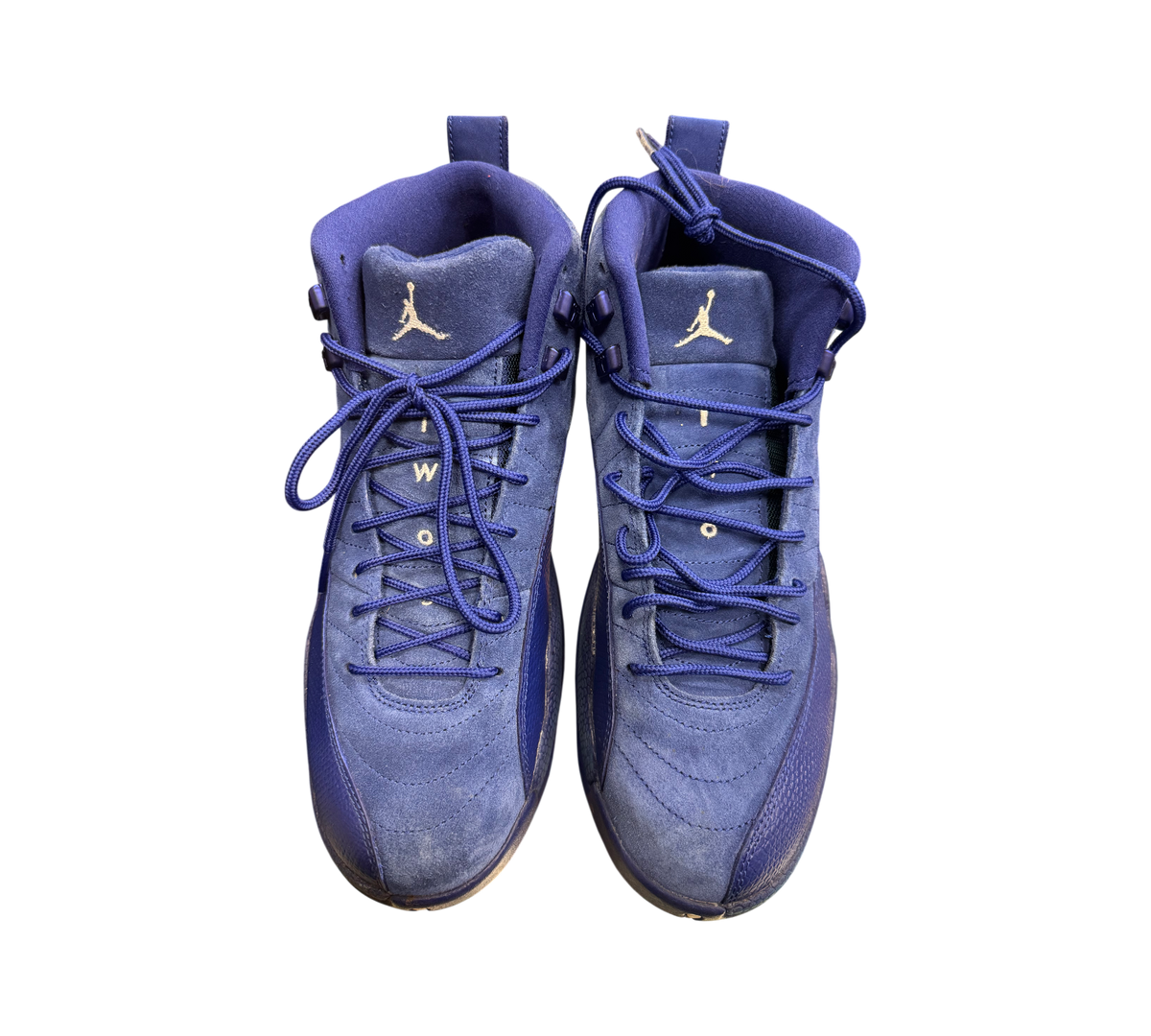 Genesis Boutique Jordan 12 Deep Royal Blue suede sneakers with white Jumpman logo and blue laces.