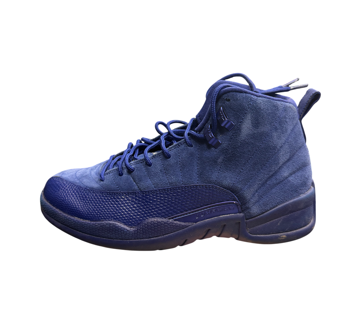 Genesis Boutique Jordan 12 Deep Royal Blue suede sneakers with textured toe box and Jumpman branding.
