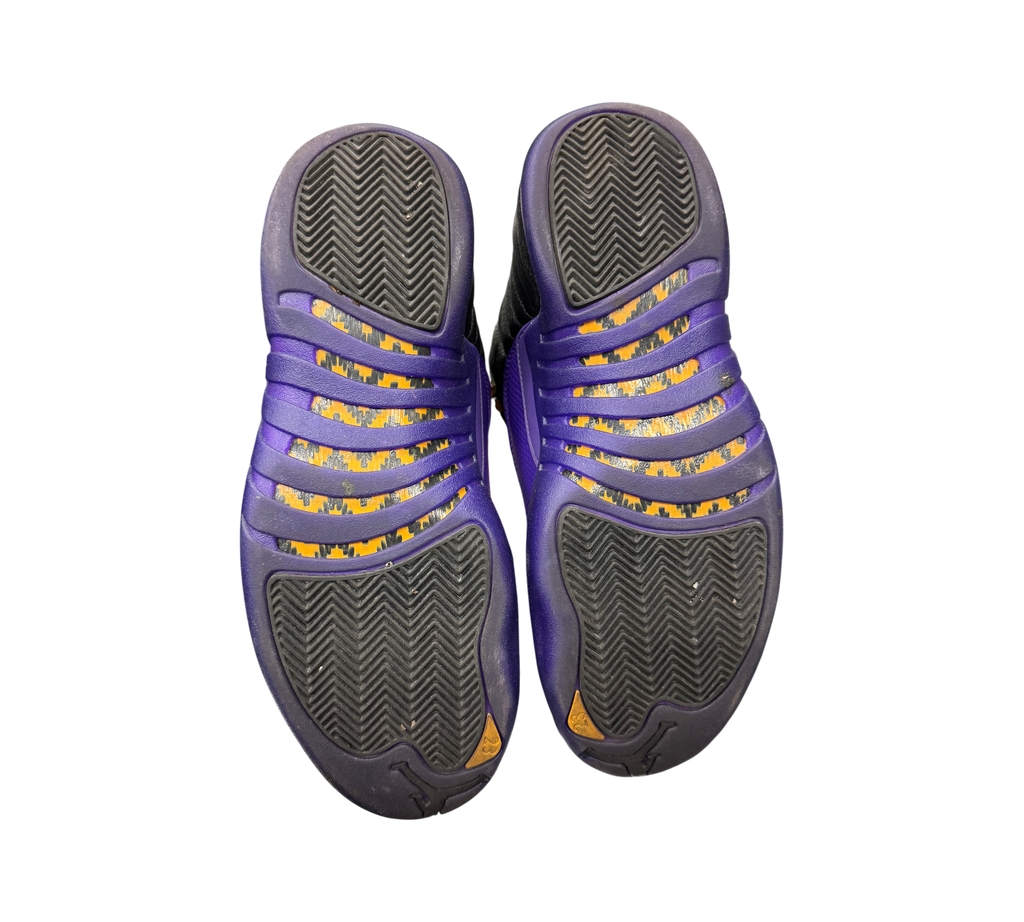 Genesis Boutique used Jordan 12 Field Purple sneakers showing the black and purple herringbone traction outsoles.