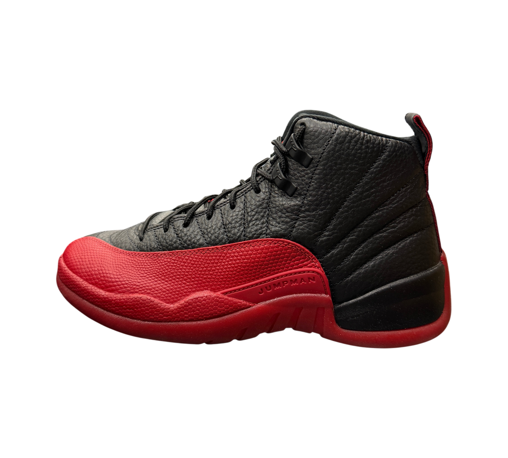 Genesis Boutique Jordan 12 Flu Game 2025 sneakers in black and red leather displayed on a glass shelf