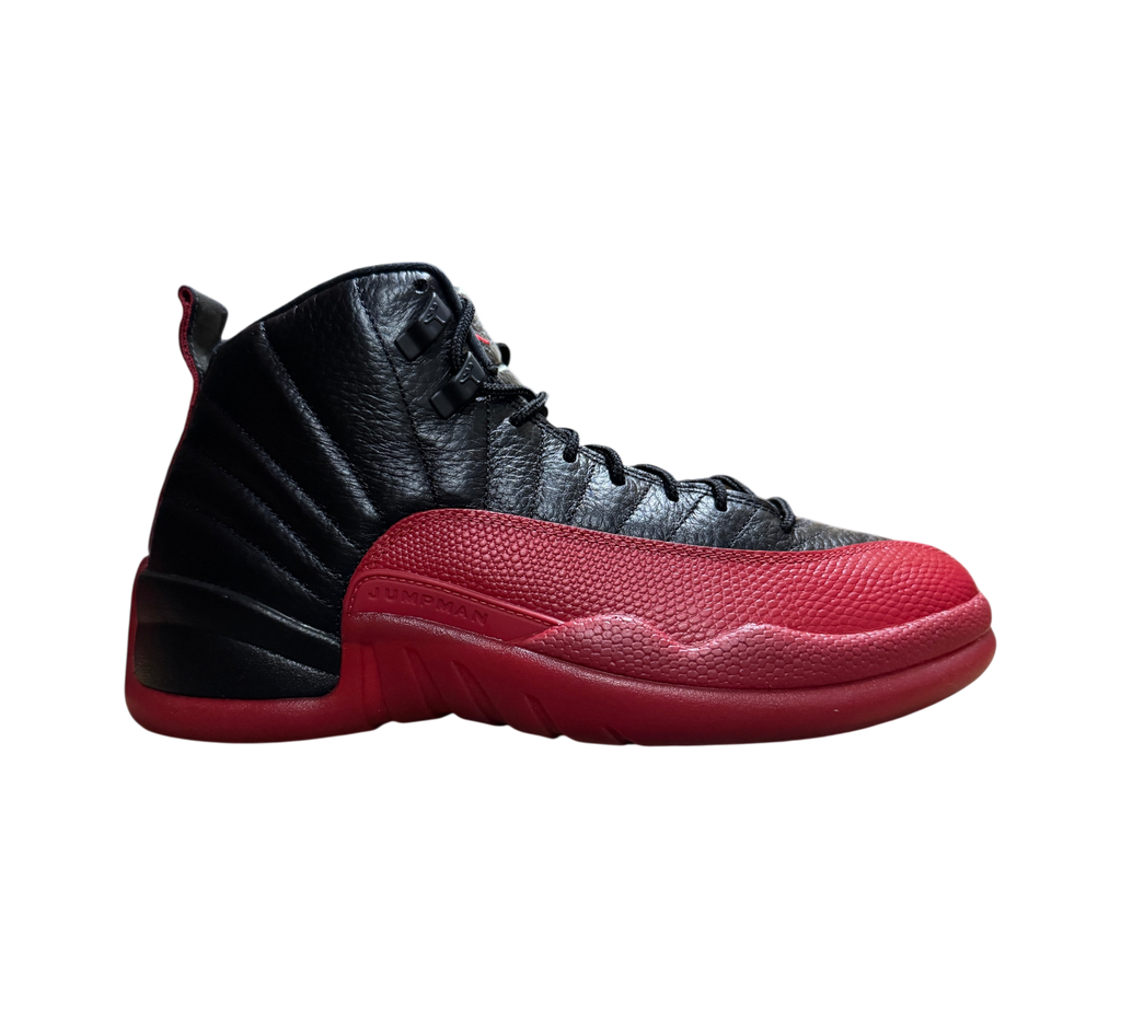 Genesis Boutique Jordan 12 Flu Game sneakers in black and red leather with textured mudguard side profile view