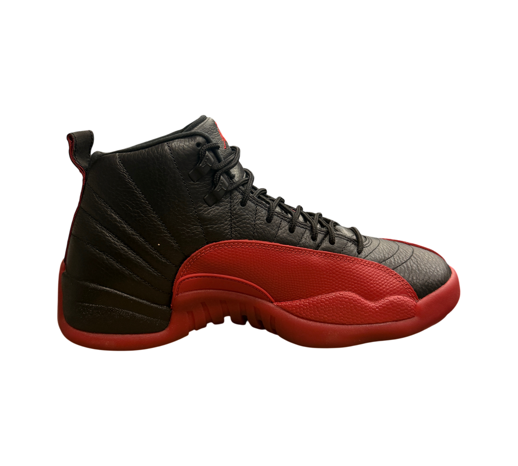 Genesis Boutique pre-owned Jordan 12 Flu Game sneakers in black and red leather on a Nike shoebox in a retail store.