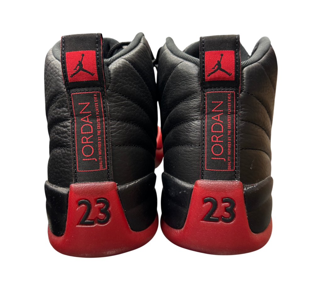 Genesis Boutique Jordan 12 Flu Game 2025 sneakers showing black leather heels with red 23 branding and Jumpman logo