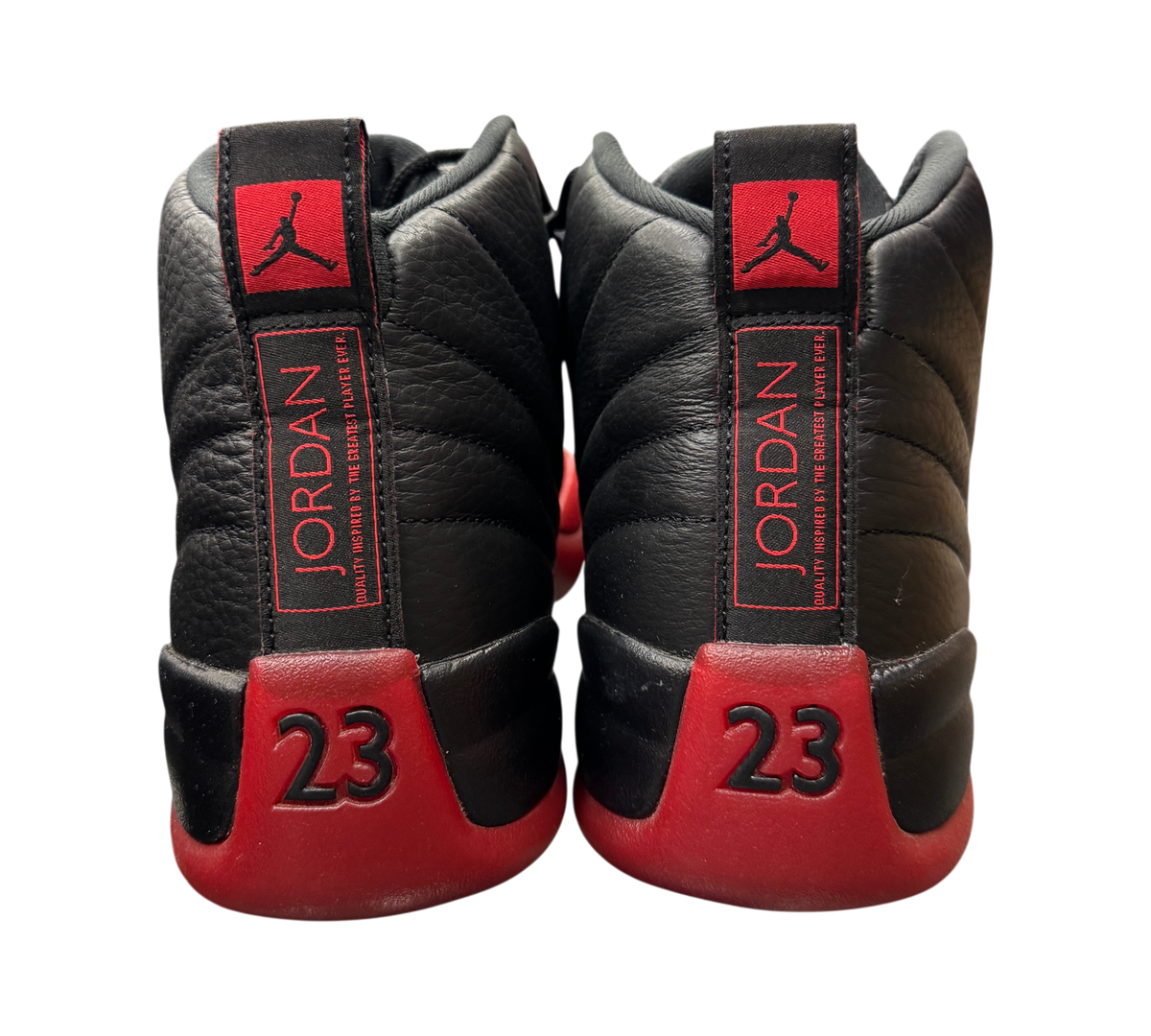 Genesis Boutique Jordan 12 Flu Game 2025 sneakers showing black leather heels with red 23 branding and Jumpman logo