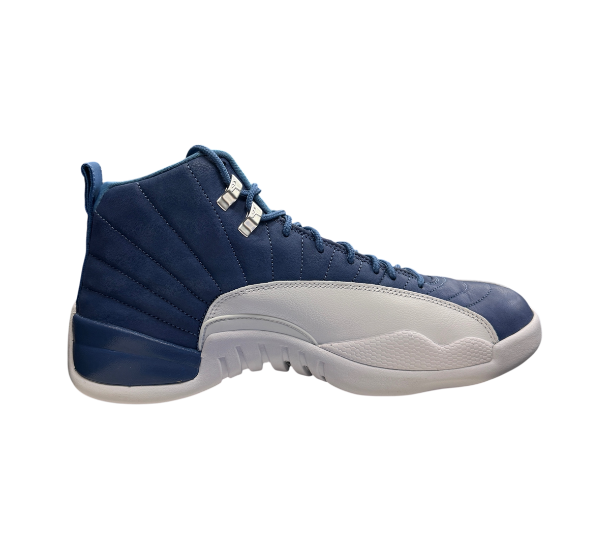 Genesis Boutique Jordan 12 Indigo sneakers in blue and white leather, side profile view on a branded shoebox.