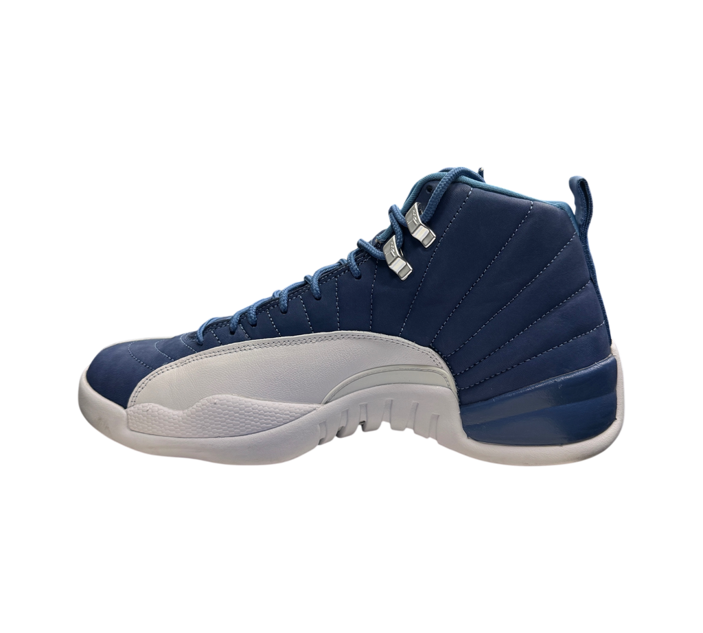 Genesis Boutique Jordan 12 Indigo sneakers in blue and white leather, side profile view in a retail store setting.