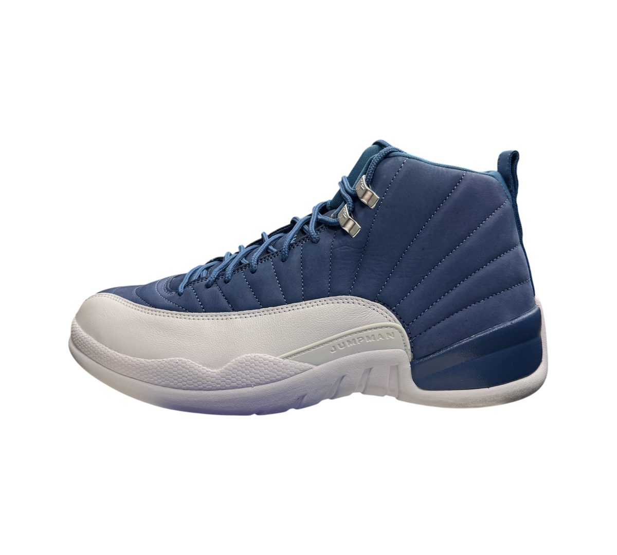 Genesis Boutique Jordan 12 Indigo sneakers in blue and white leather with silver eyelets on a display box