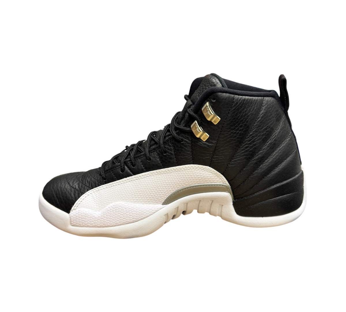 Genesis Boutique Jordan 12 Playoff sneakers in black and white leather with gold eyelets on a shoebox