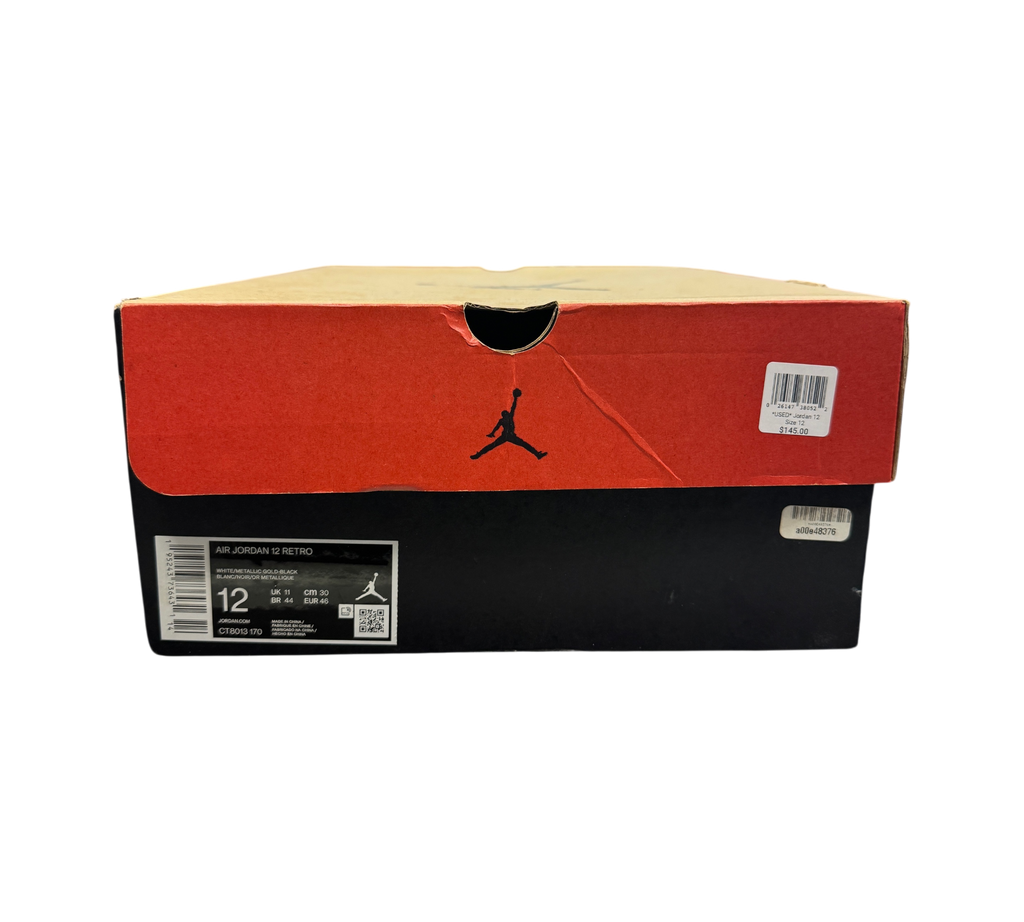 Genesis Boutique Jordan 12 Royalty Taxi sneaker box with black and red branding on a retail store display counter