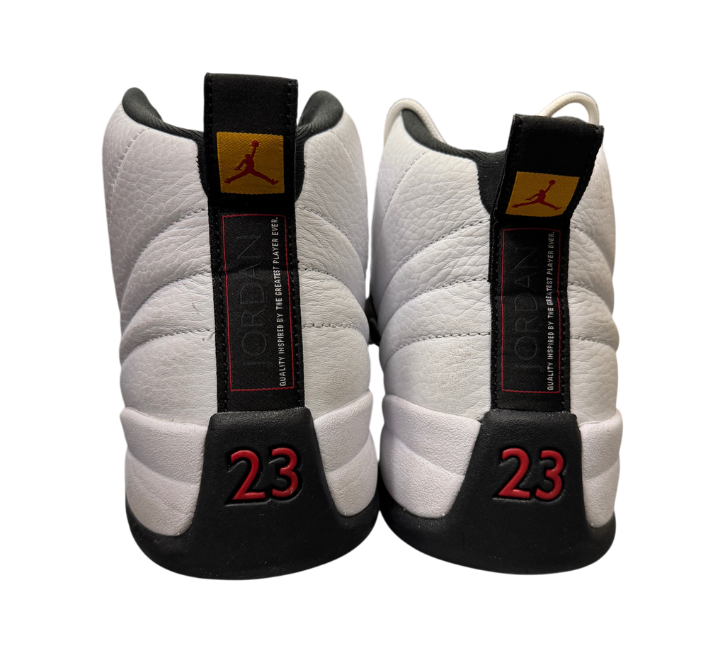 Genesis Boutique pre-owned Jordan 12 Taxi sneakers featuring white leather, black accents, and red 23 heel branding.