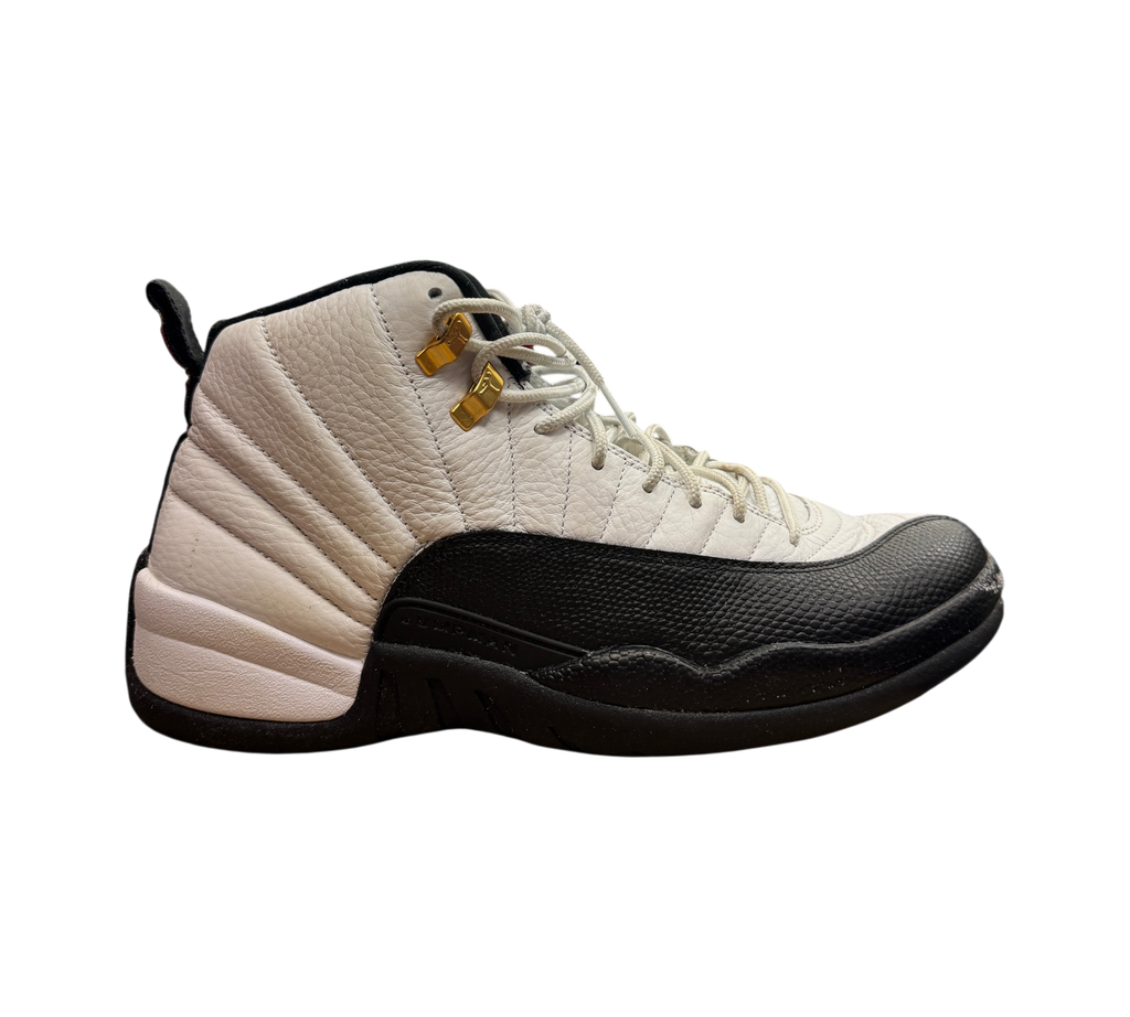Genesis Boutique pre-owned Jordan 12 Taxi sneakers in white and black leather with gold eyelets on a Nike box