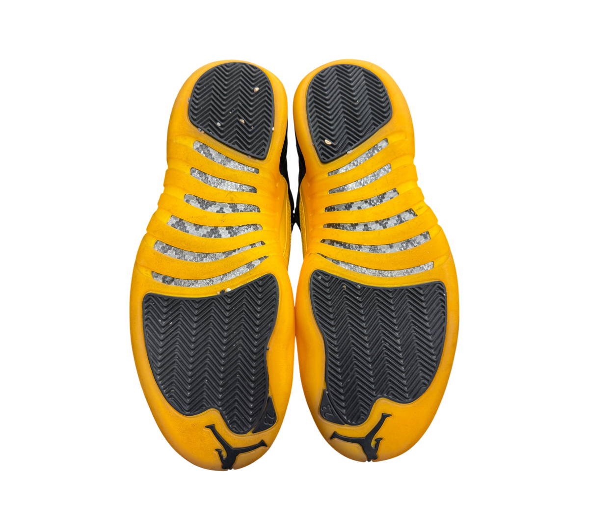 Genesis Boutique used Jordan 12 University Gold sneakers showing the black and yellow rubber outsoles