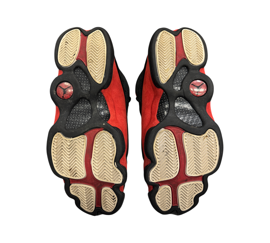 Genesis Boutique used Jordan 13 Bred sneakers showing the black and red paw-print outsoles with Jumpman logos