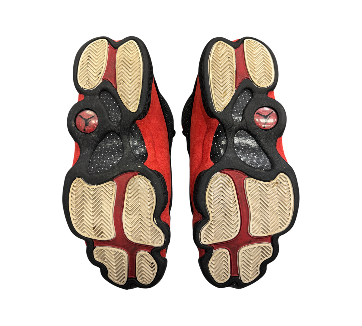 Genesis Boutique used Jordan 13 Bred sneakers showing the black and red paw-print outsoles with Jumpman logos