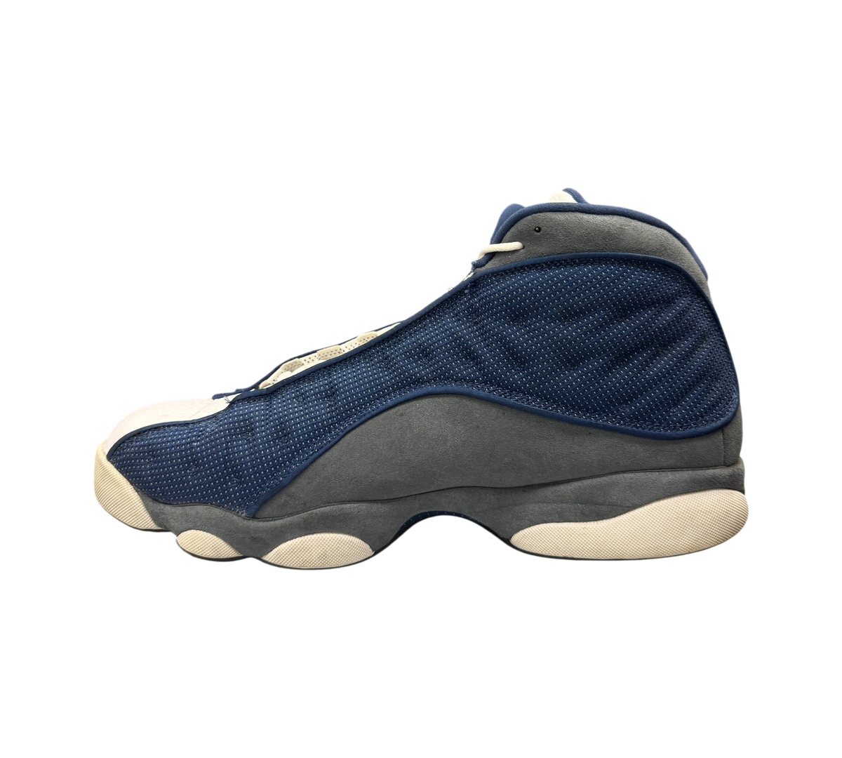 Genesis Boutique Jordan 13 Flint sneaker in navy blue and grey suede with white midsole, side profile view.