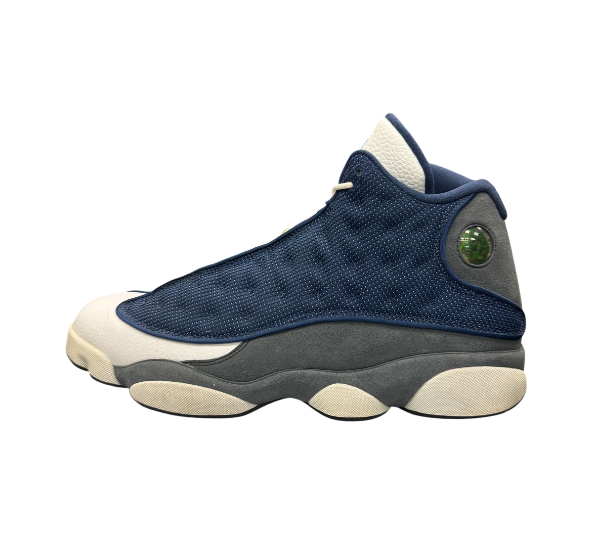 Genesis Boutique used Jordan 13 Flint sneakers in navy blue, grey, and white with signature holographic heel emblem.