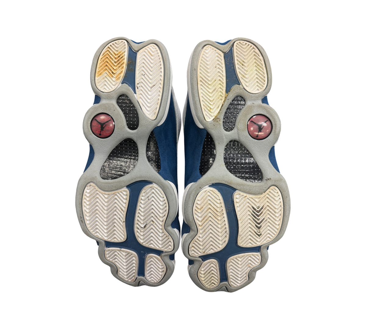 Genesis Boutique used Jordan 13 French Blue sneakers showing the white and blue rubber outsoles with Jumpman logos.