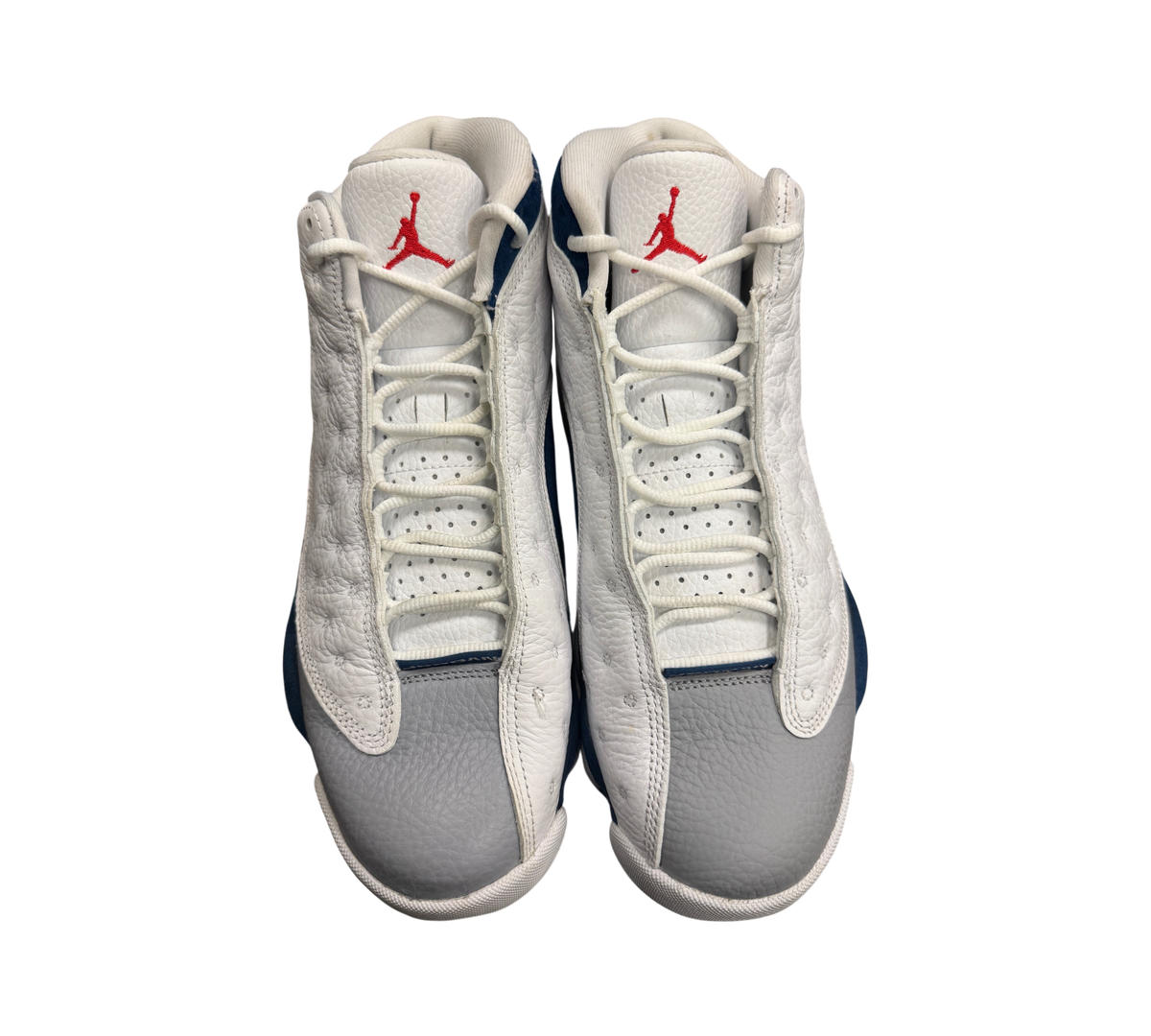 Genesis Boutique Jordan 13 French Blue sneakers featuring white and grey leather with red Jumpman logo details.