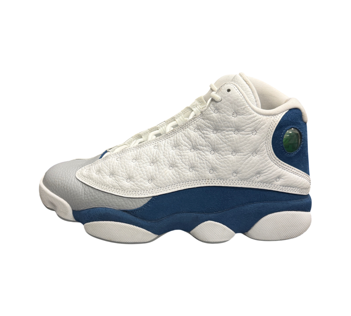 Genesis Boutique Jordan 13 French Blue sneakers featuring white quilted leather, grey toe, and blue suede accents.