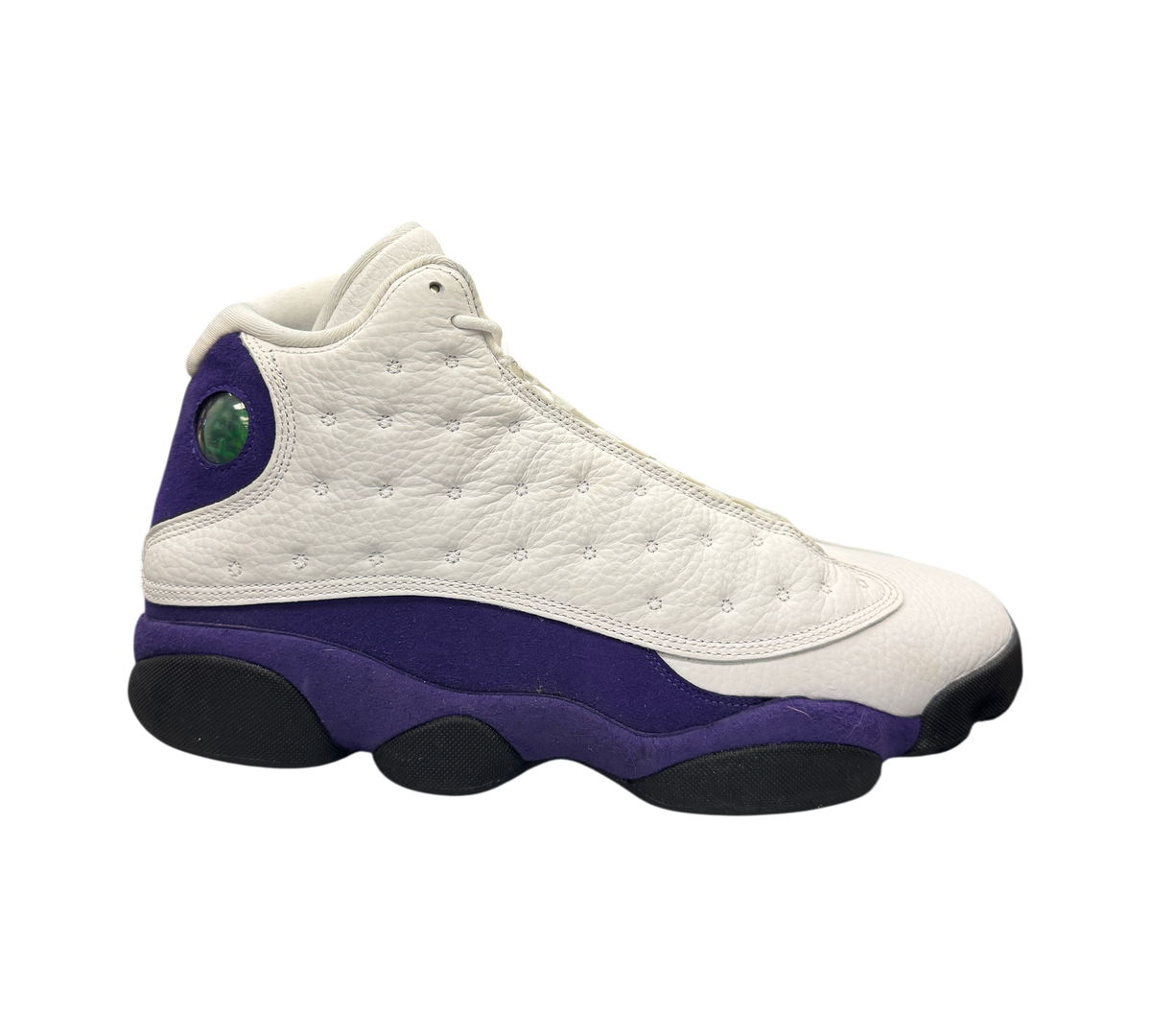 Genesis Boutique Jordan 13 Lakers sneakers in white leather and purple suede with signature holographic heel emblem.