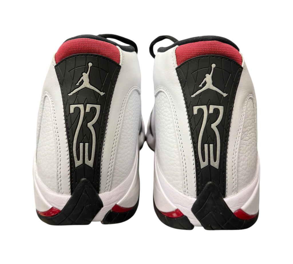 Genesis Boutique Jordan 14 Black Toe sneakers showing the white leather heel, red accents, and 23 branding.