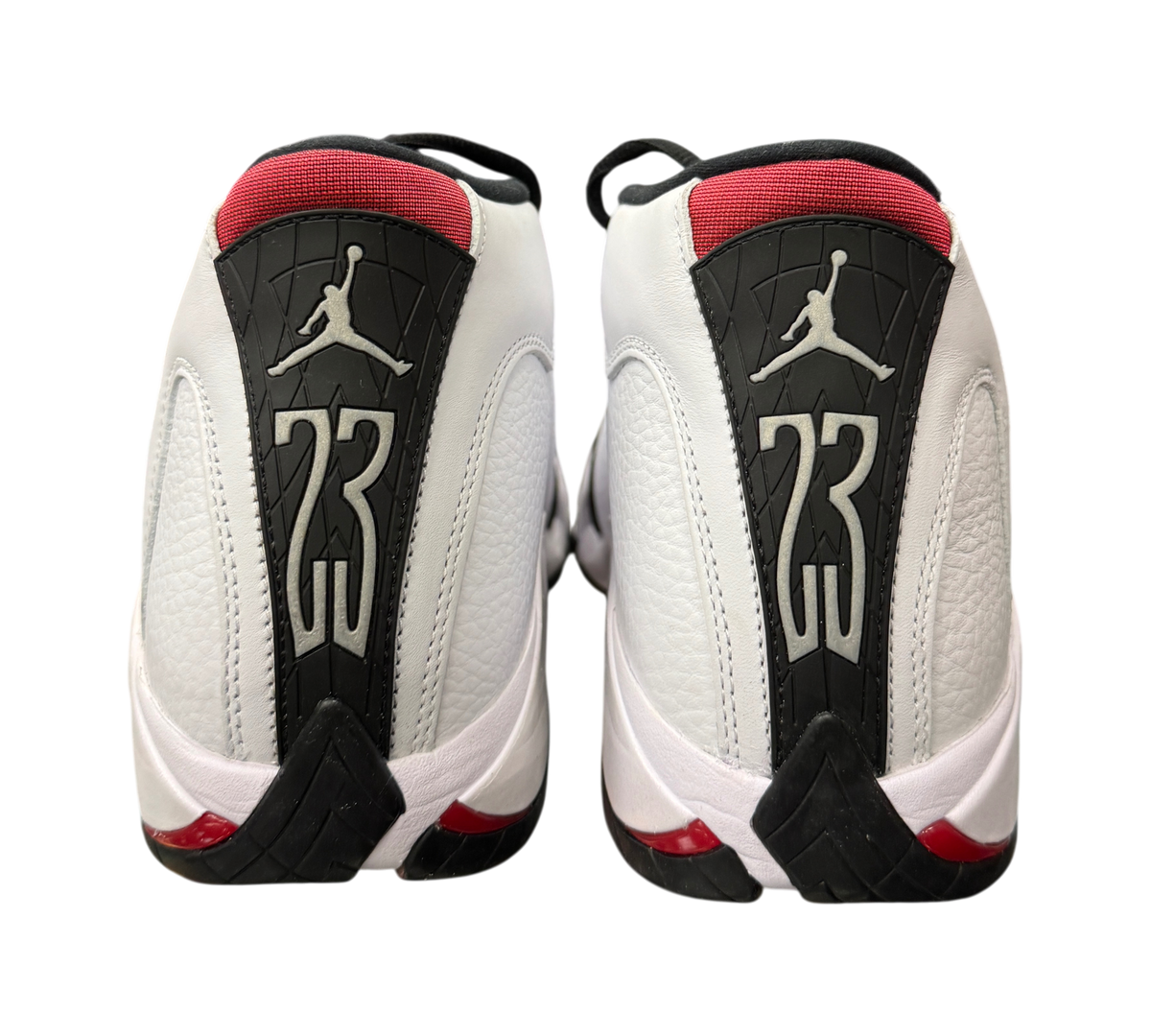 Genesis Boutique Jordan 14 Black Toe sneakers showing the white leather heel, red accents, and 23 branding.