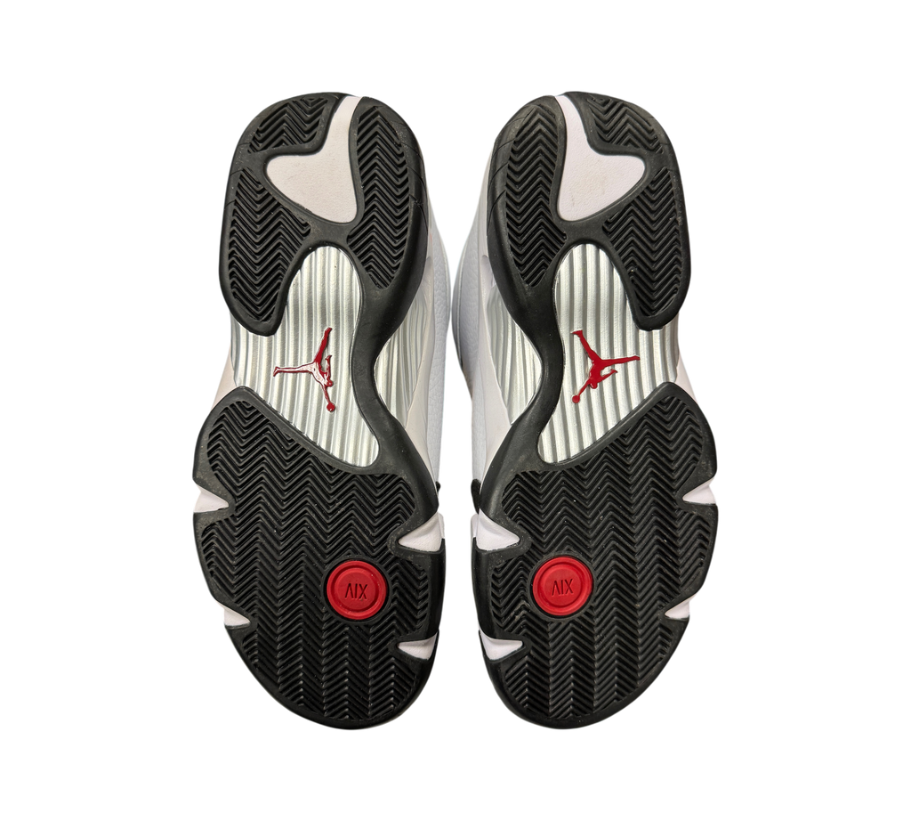 Genesis Boutique Jordan 14 Black Toe sneakers showing the black, white, and red patterned rubber outsoles