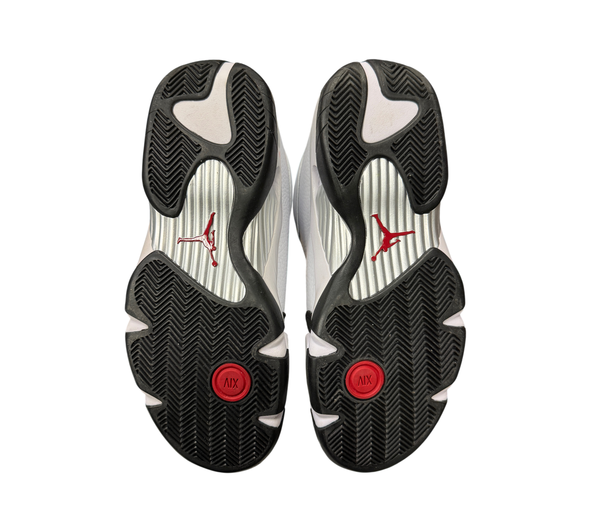 Genesis Boutique Jordan 14 Black Toe sneakers showing the black, white, and red patterned rubber outsoles