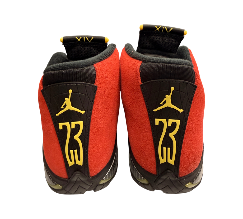 Genesis Boutique Jordan 14 Ferrari sneakers in red suede with yellow Jumpman and 23 branding on the heel.