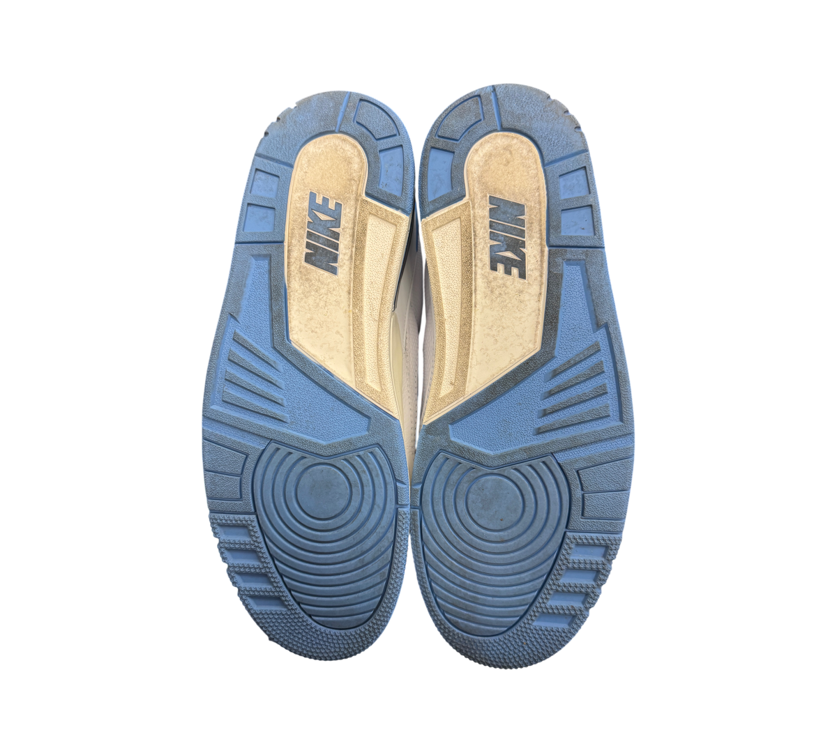 Genesis Boutique used Jordan 2/3 UNC sneakers showing the light blue and white rubber outsoles with Nike branding.