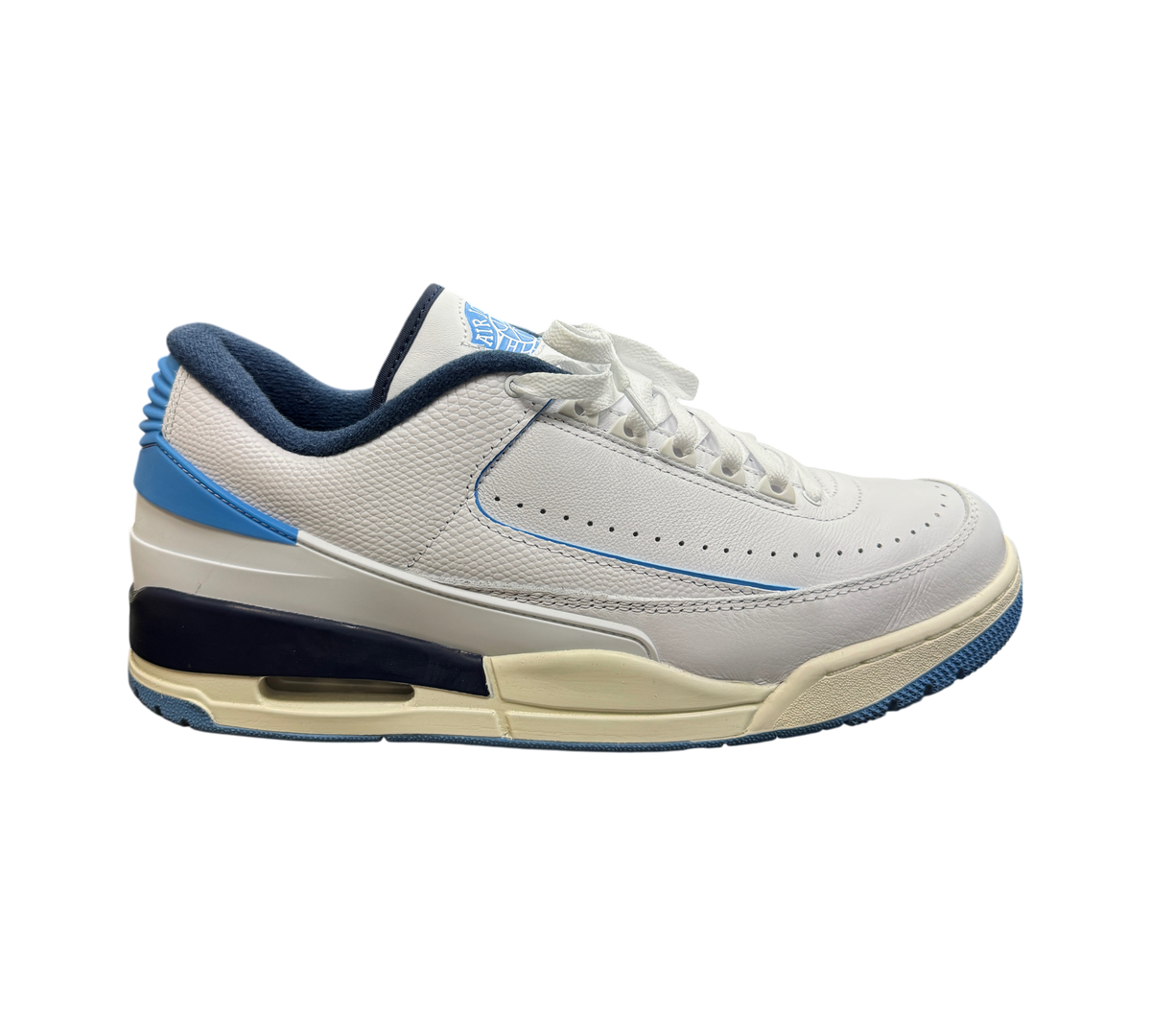 Genesis Boutique Jordan 2/3 UNC sneaker in white leather with university blue and navy accents on a glass display case