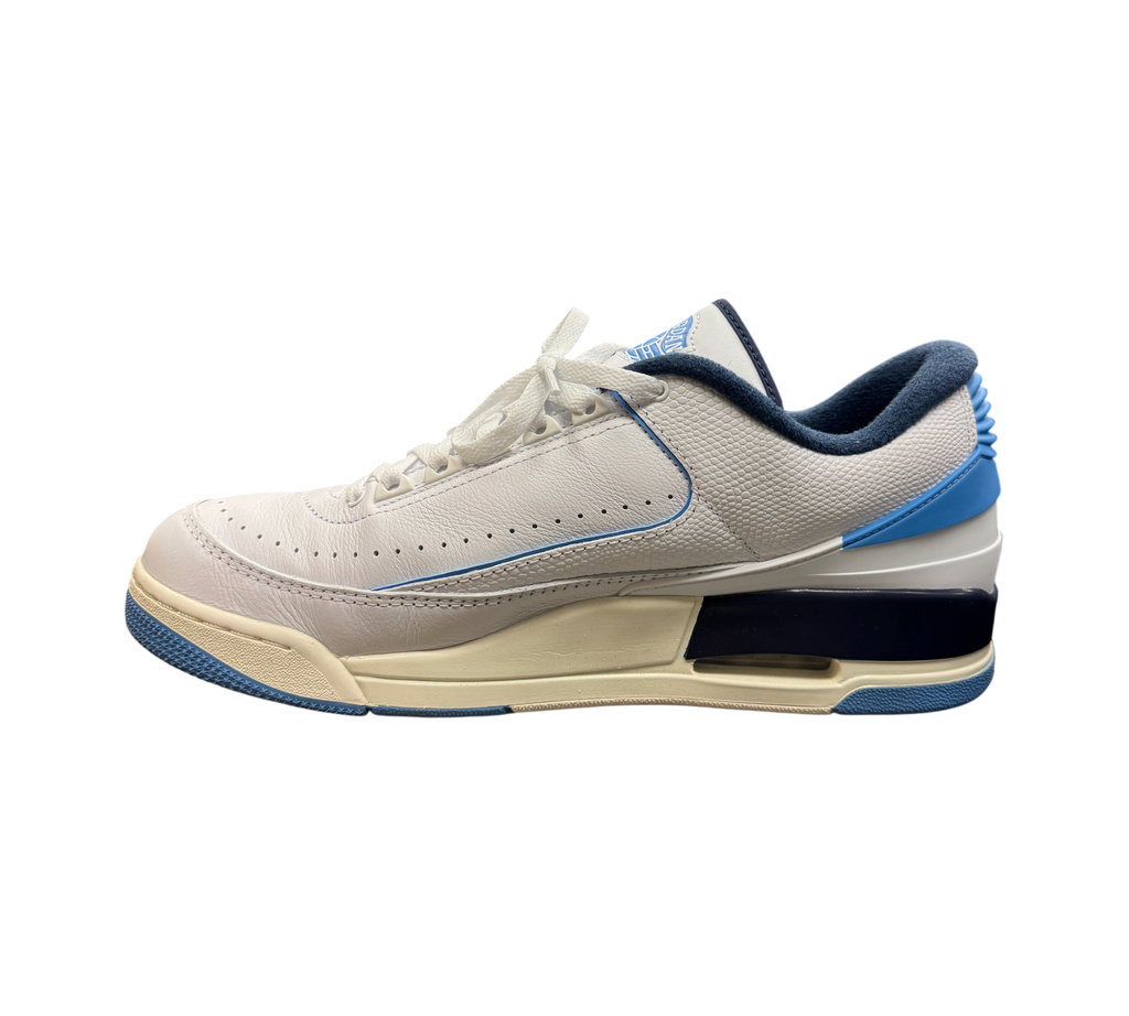 Genesis Boutique Jordan 2/3 UNC sneakers in white leather with university blue and navy accents on a glass display